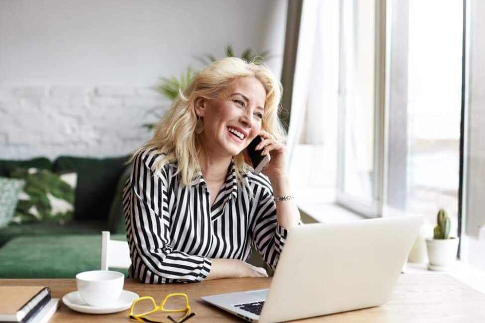 Happy woman talking on the phone because her W-2 from a previous employer is available