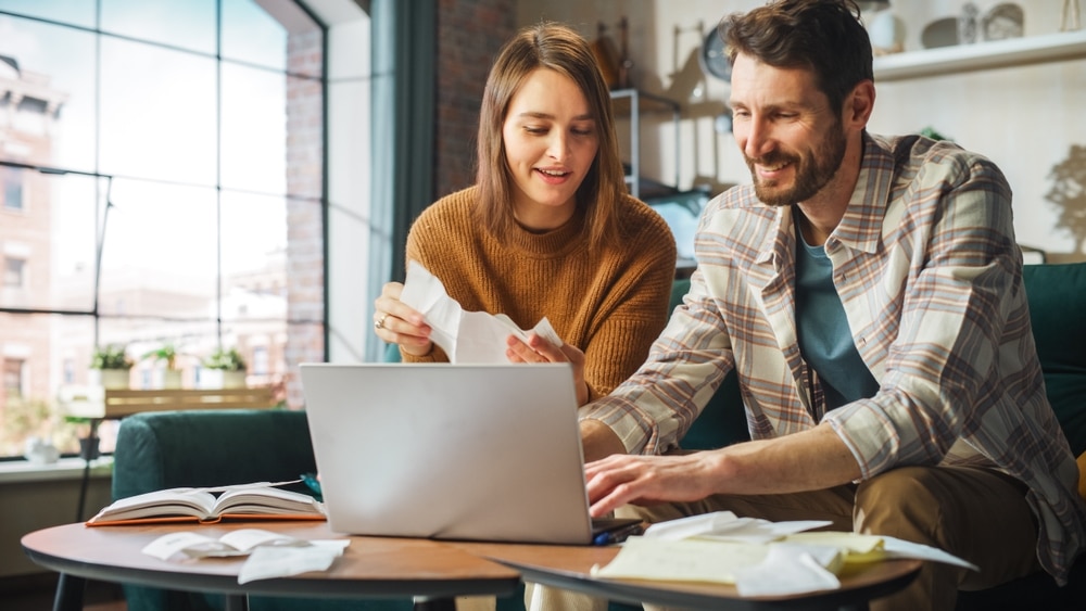 Happy couple claiming different tax credits to reduce their tax burden